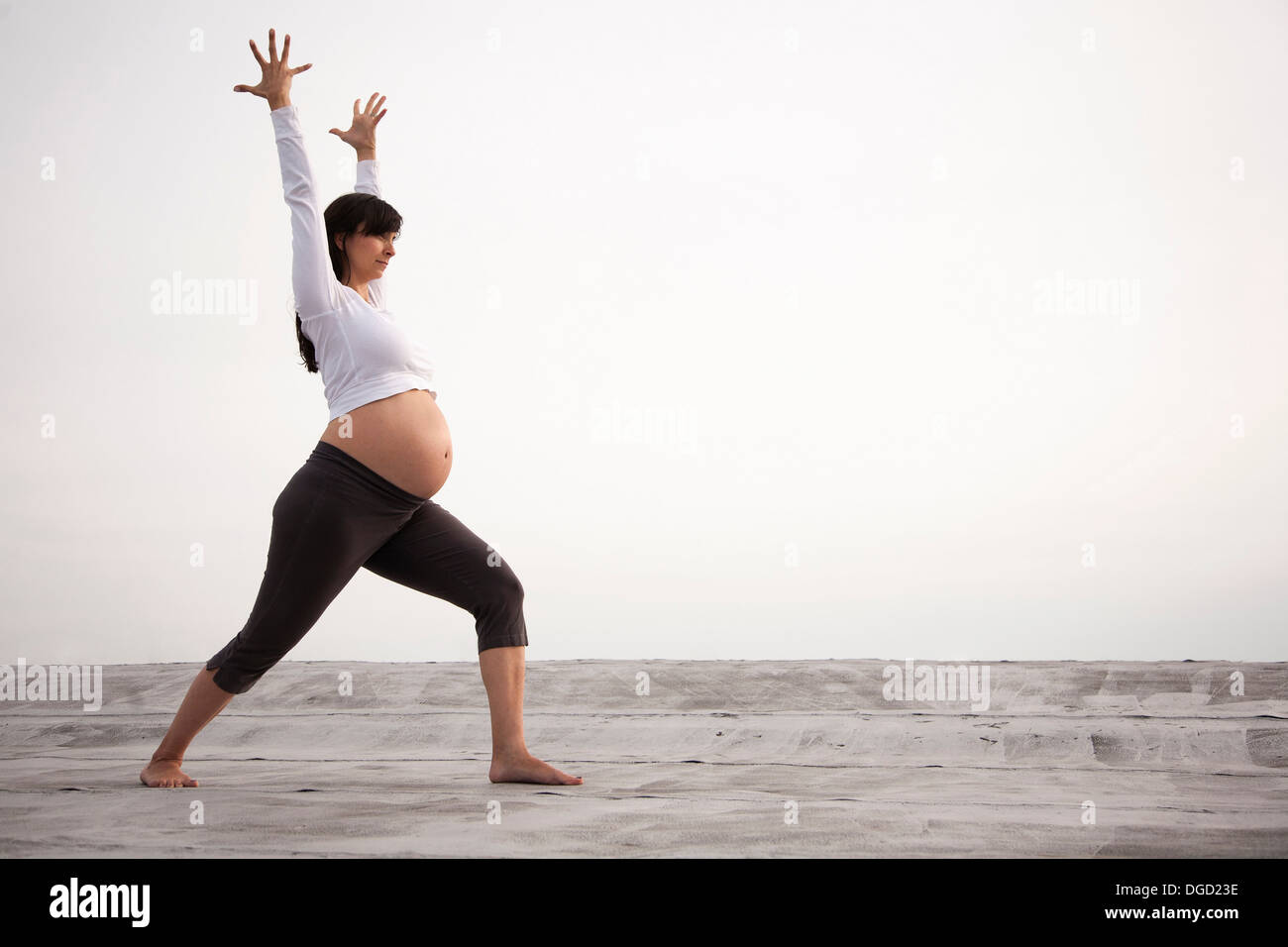 Pregnant Young Woman Doing Prenatal Yoga. Warrior Two Pose Stock