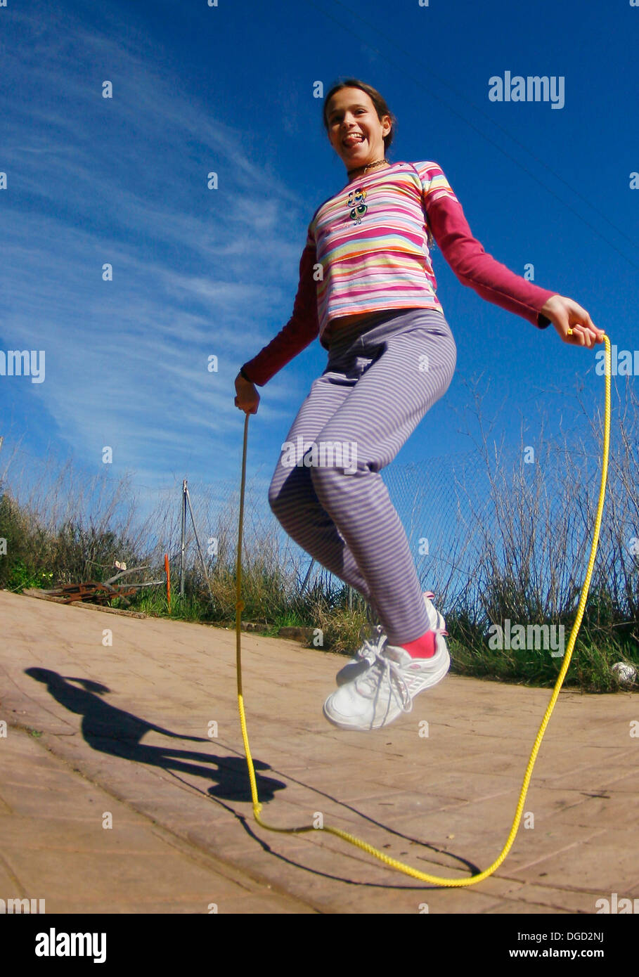 A young girl jumps a rope. Stock Photo