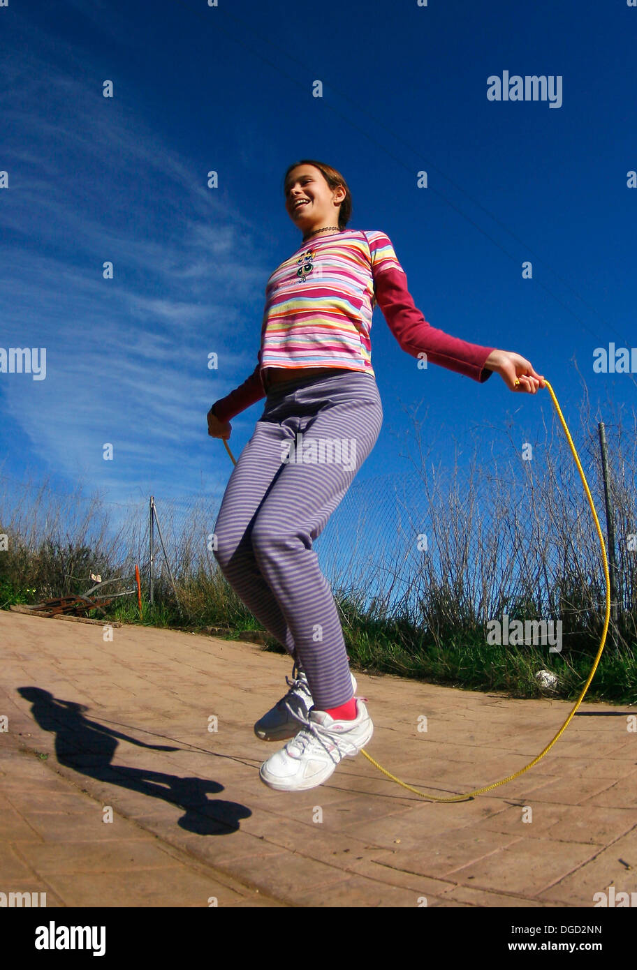 A young girl jumps a rope. Stock Photo