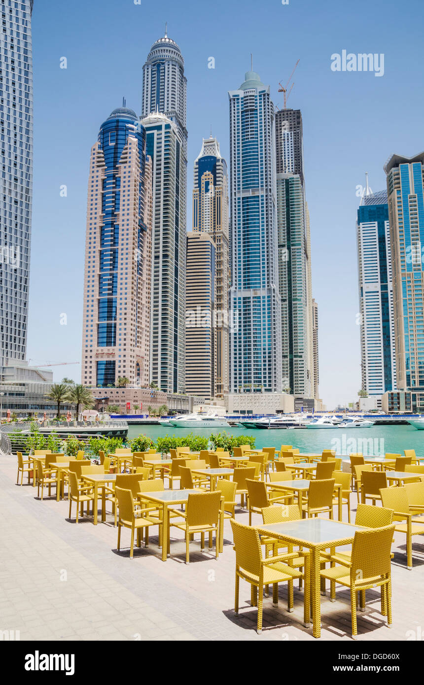 Empty restaurant tables and chairs on the promenade around Dubai Marina, Dubai, United Arab Emirates Stock Photo