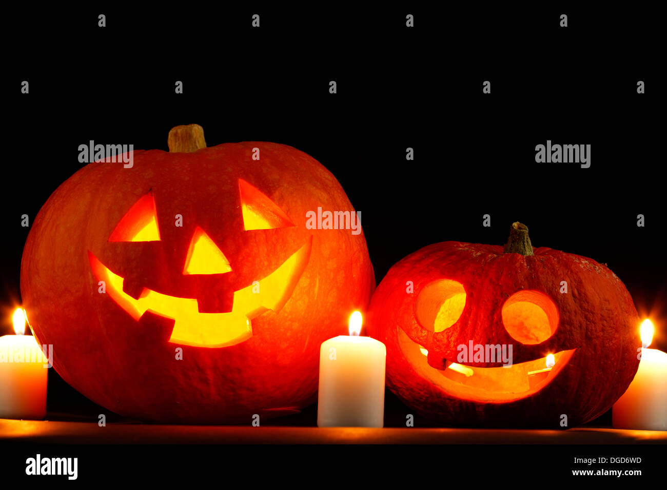 Funny Halloween pumpkins and burning candles Stock Photo