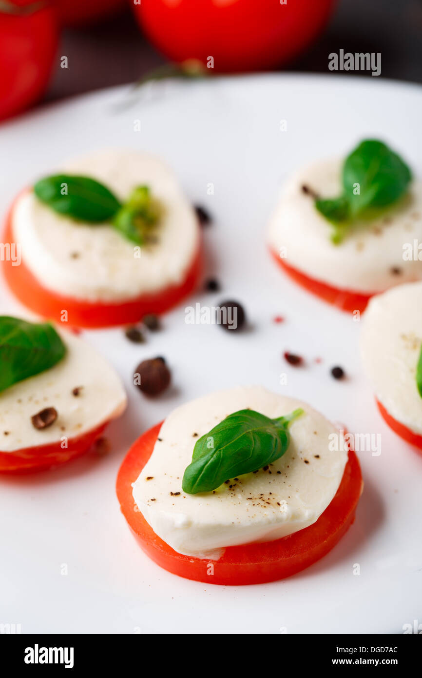 Tomato and mozzarella with basil leaves Stock Photo - Alamy