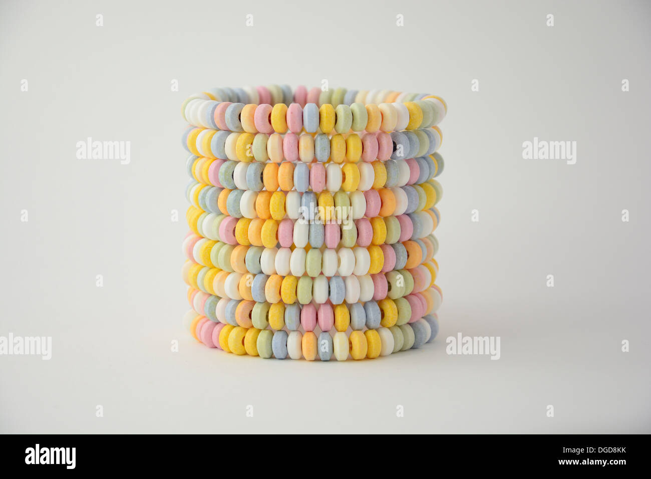 Tower Made From Candy Necklaces Isolated On White Studio Background Stock Photo