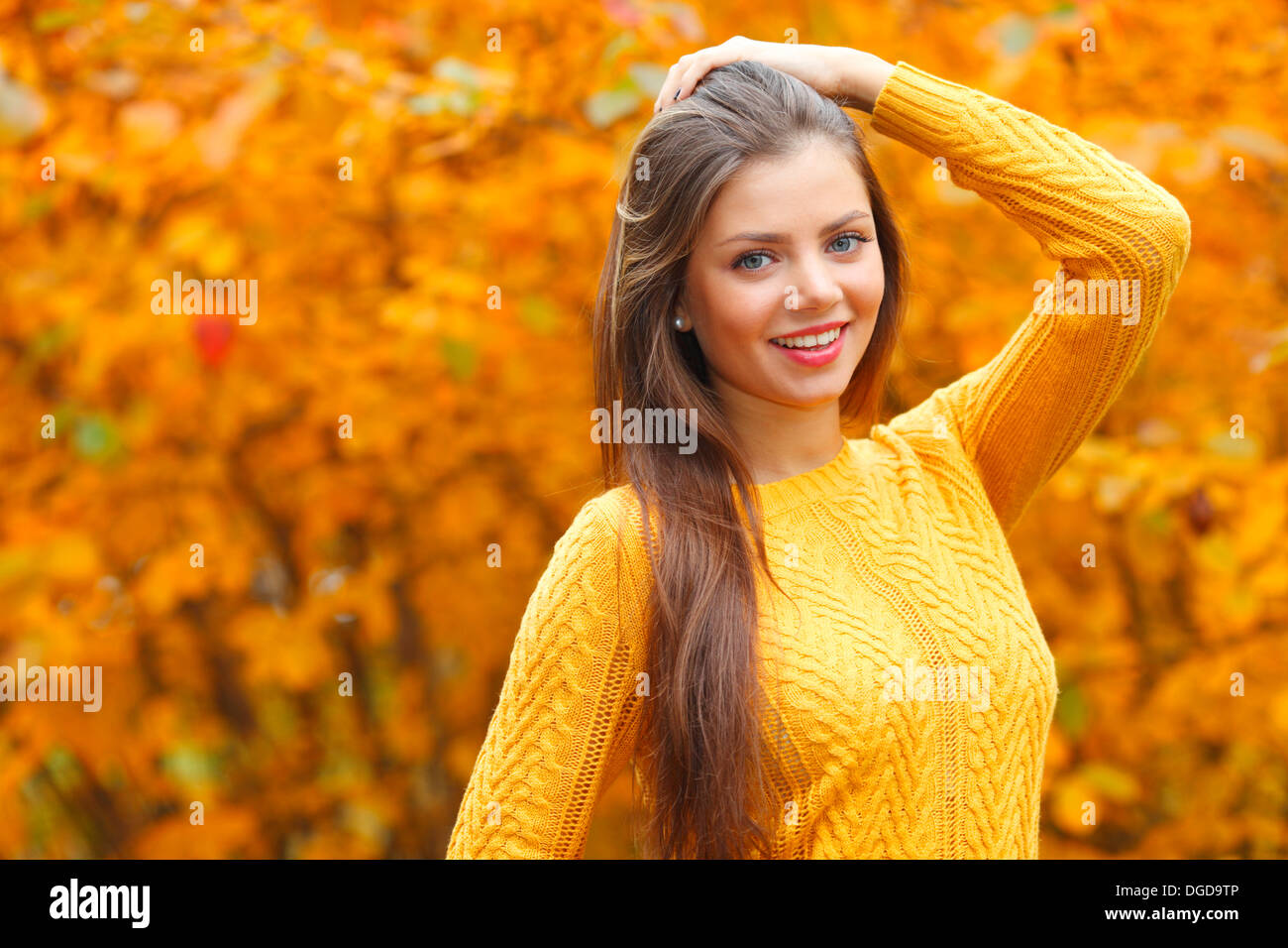 Portrait of a beautiful young woman over autumn tree background Stock ...