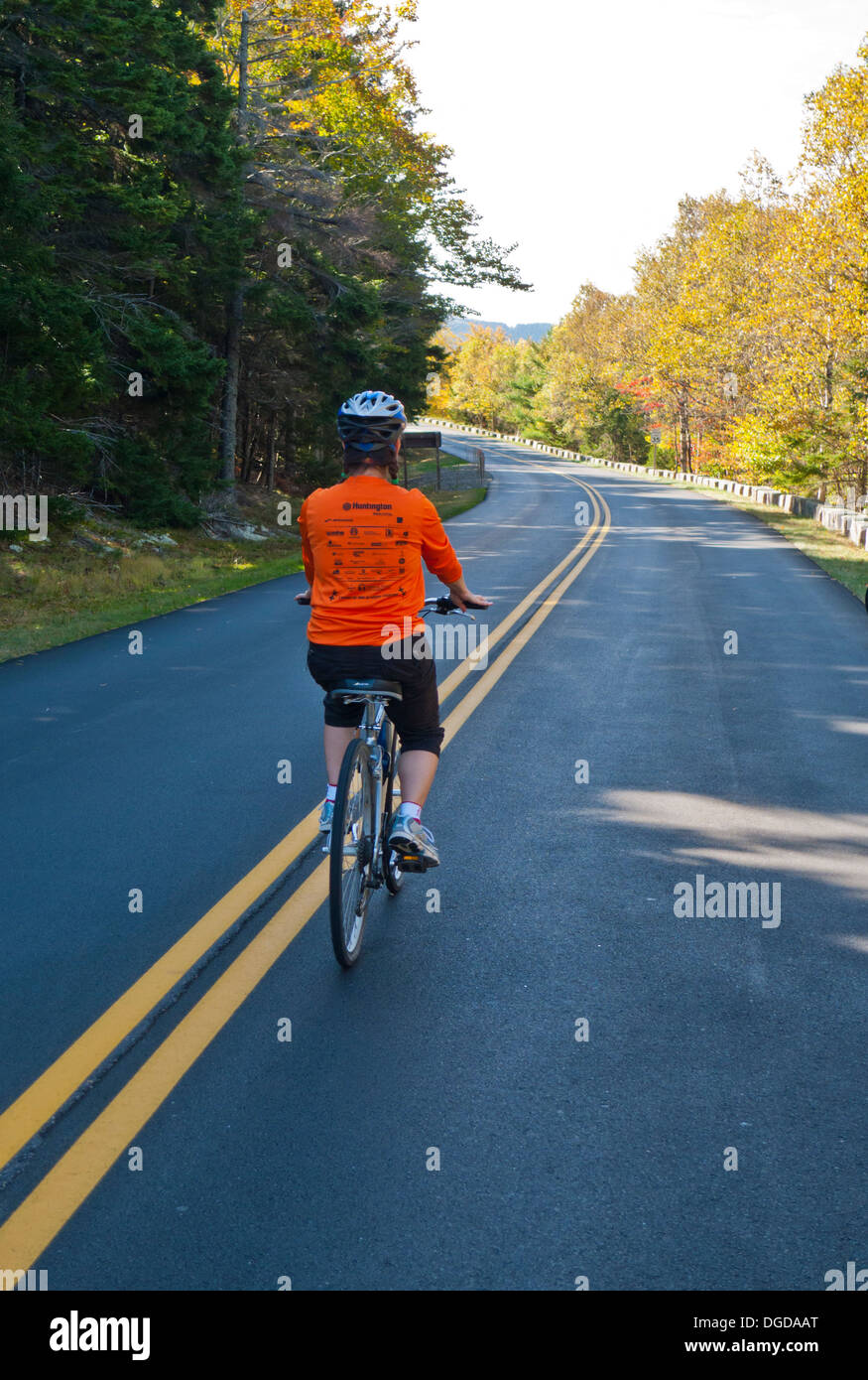 A woman rides on a traffic-free loop road in a closed Acadia National Park during the government shut-down of October 2013 Stock Photo