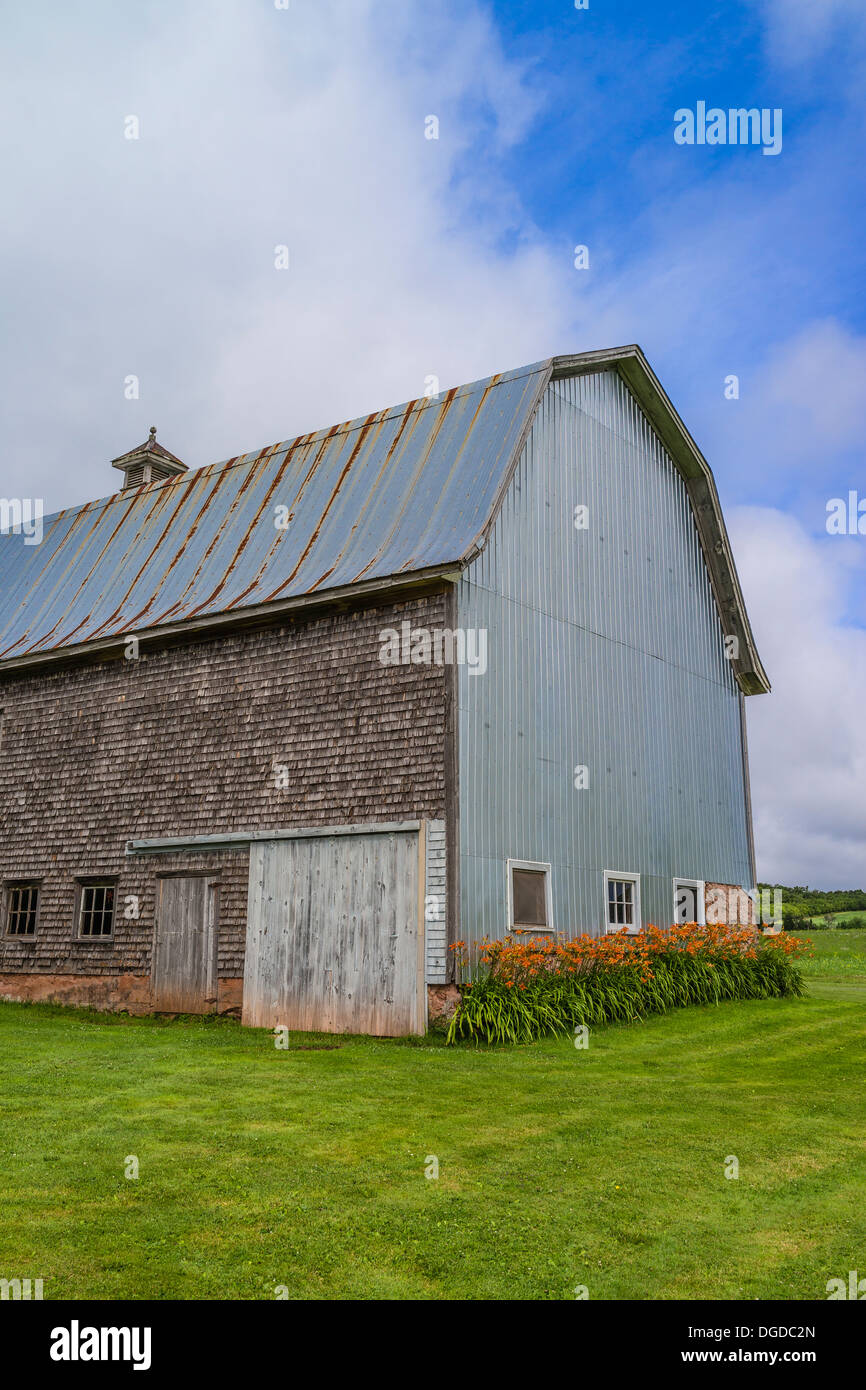 Old weathered shake shingle sided barn with rusted metal roof Prince Edward Island, one of the Maritime Provinces in Canada. Stock Photo