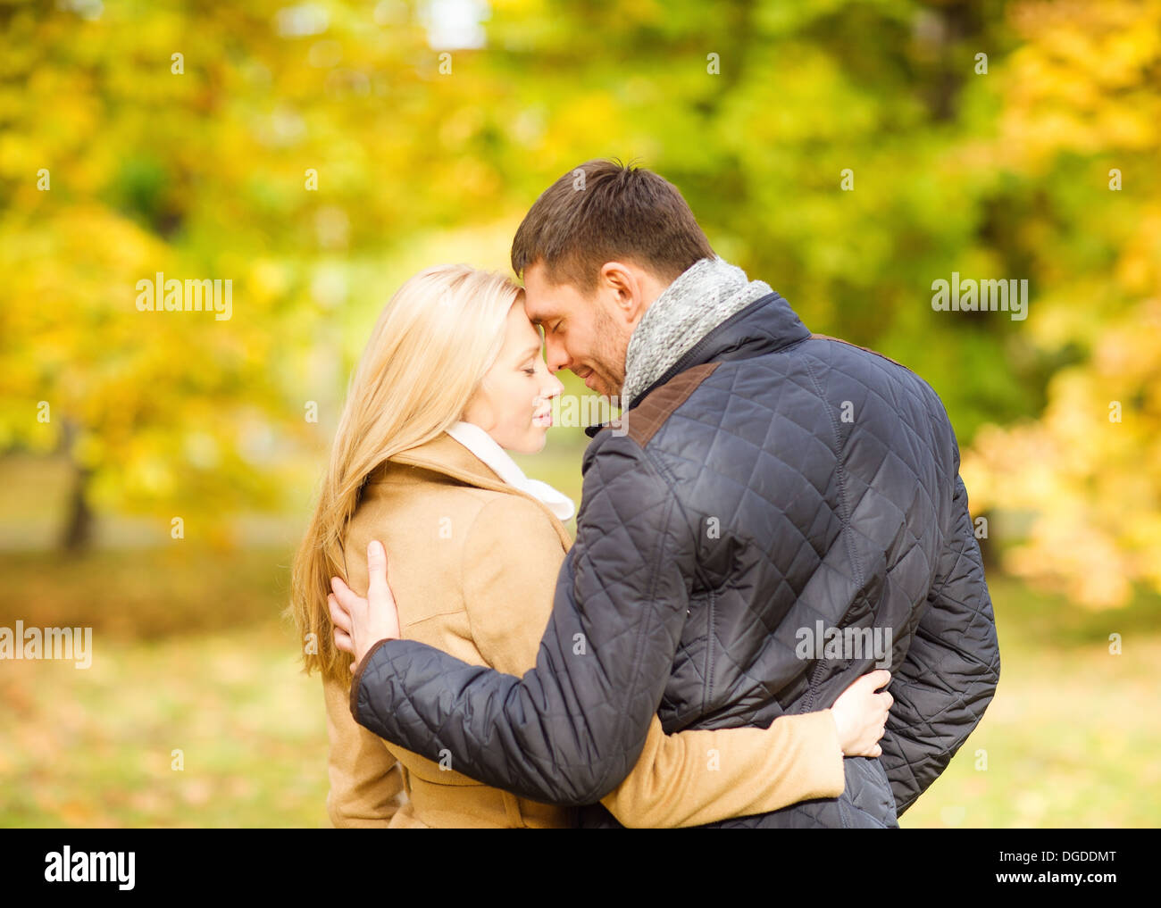 Romantic Couple Kissing In The Autumn Park Stock Photo - Alamy