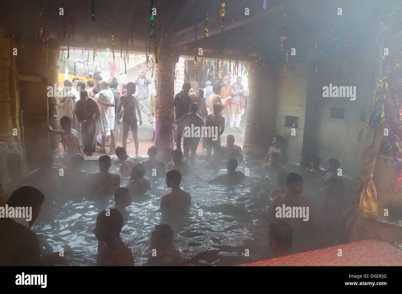 Hindu pilgrims bathing in hot springs below the Badrinath temple, India Stock Photo