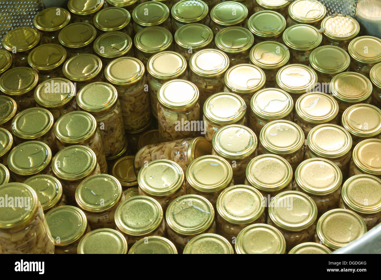 glass jars in the machine for pasteurization Stock Photo
