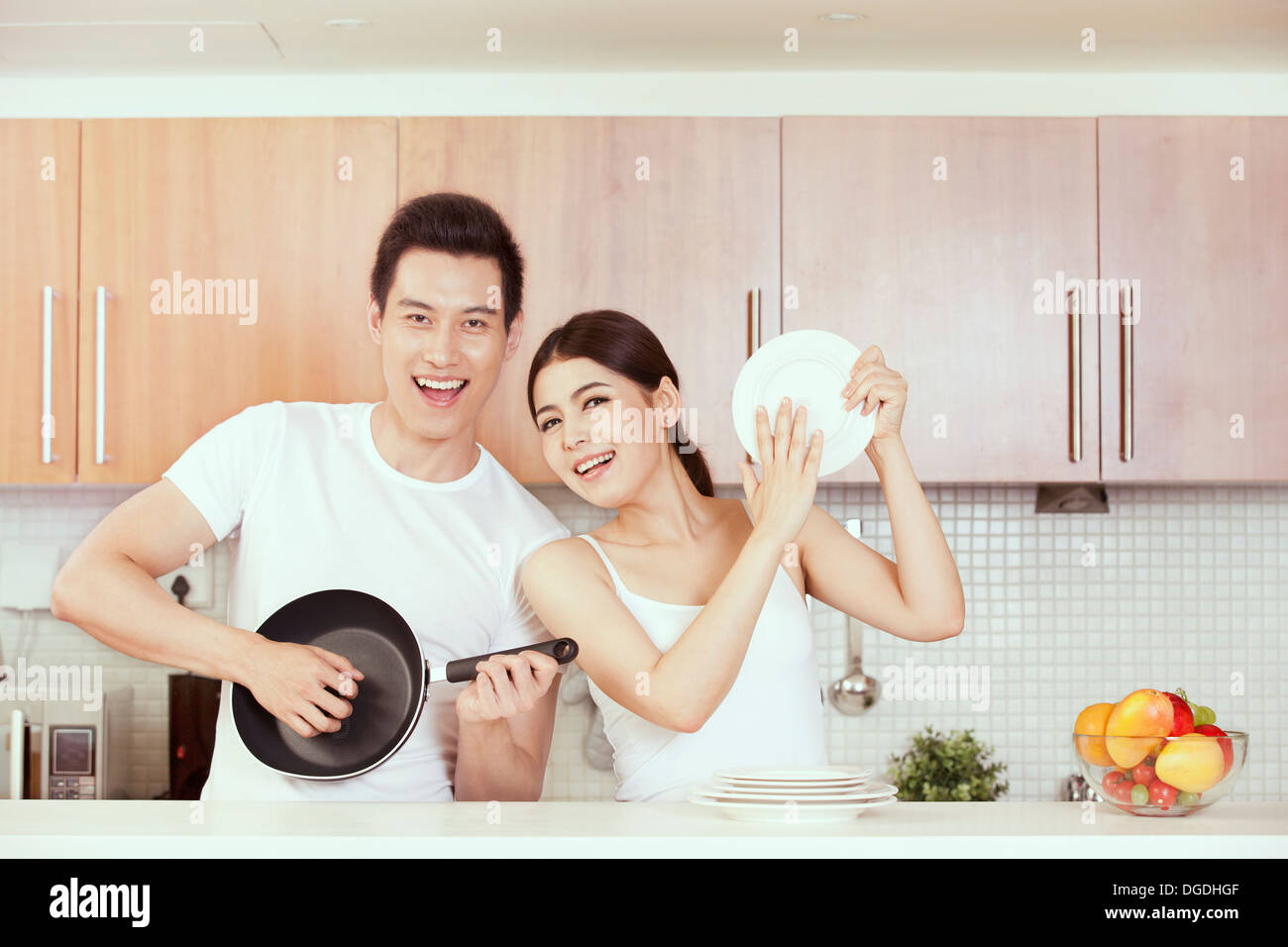 East Asian Young Couple Having Fun in Kitchen Stock Photo