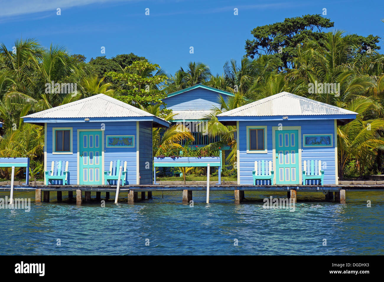 Overwater bungalows with palm trees in background, Bocas del Toro, Caribbean sea, Central America, Panama Stock Photo