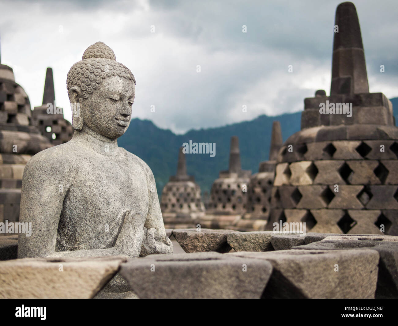 Ancient Buddha statue at Borobudur, the world's largest Buddhist monument in Java, Indonesia. Stock Photo