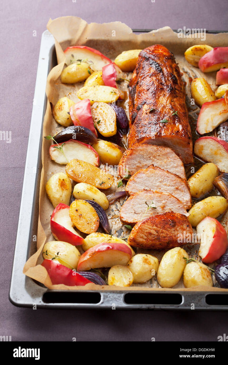 pork baked with vegetables on a tray Stock Photo - Alamy