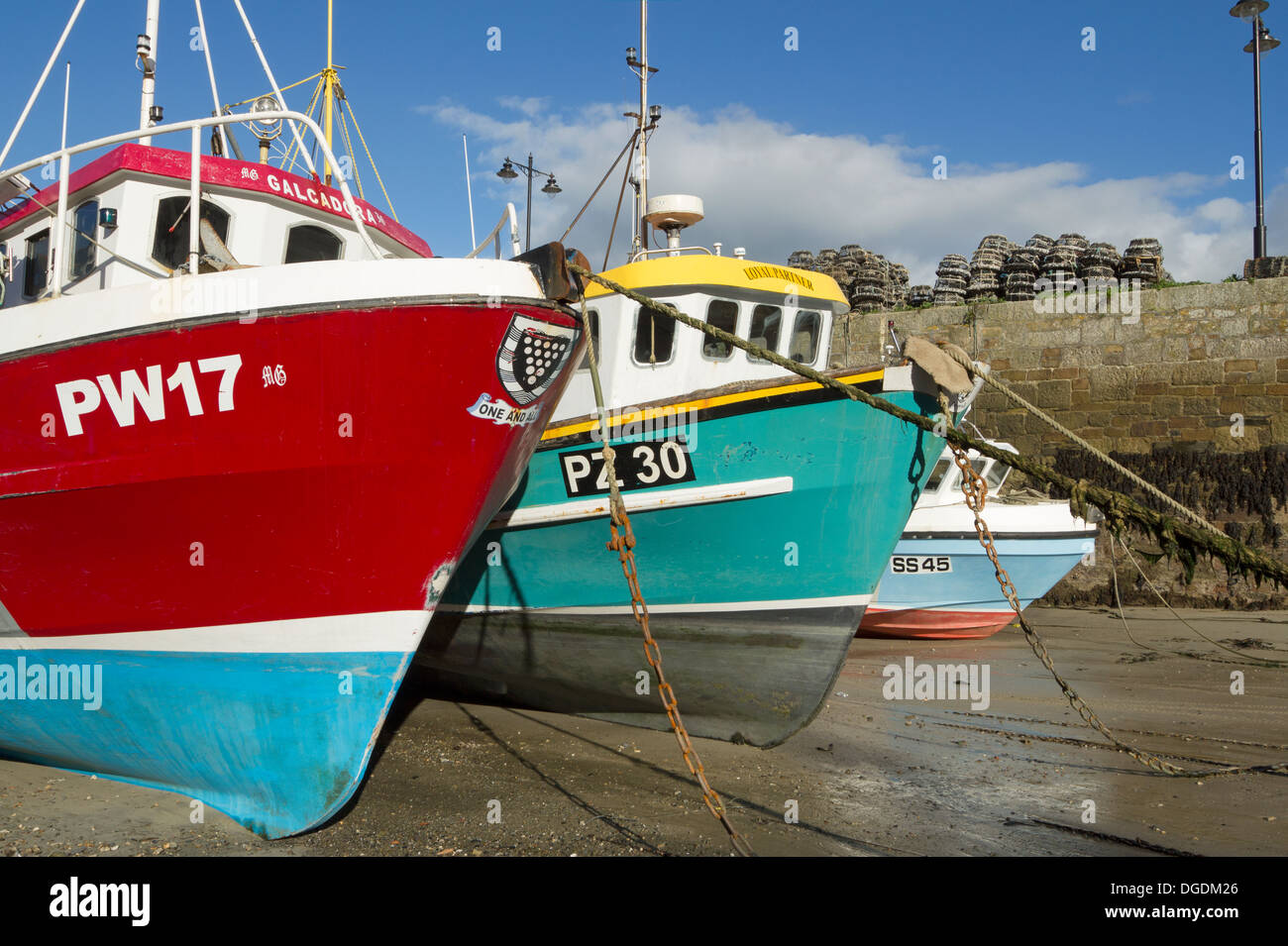 Colourful fishing boats in Newquay harbour at low tide, Cornwall England UK. Stock Photo