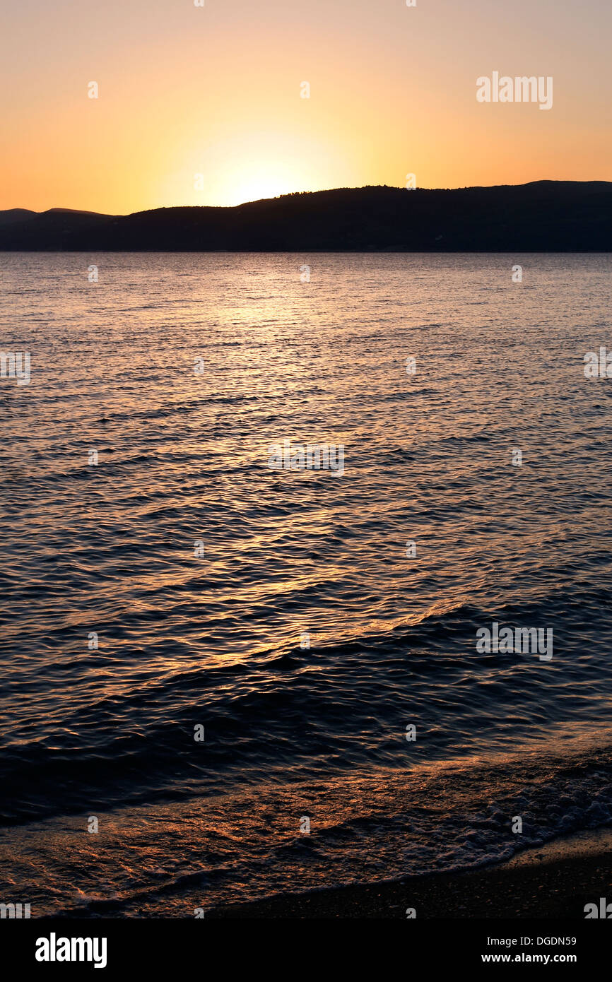 Sunset at Agia Eleni Beach on the Greek Island of Skiathos in the Aegean Sea. Stock Photo