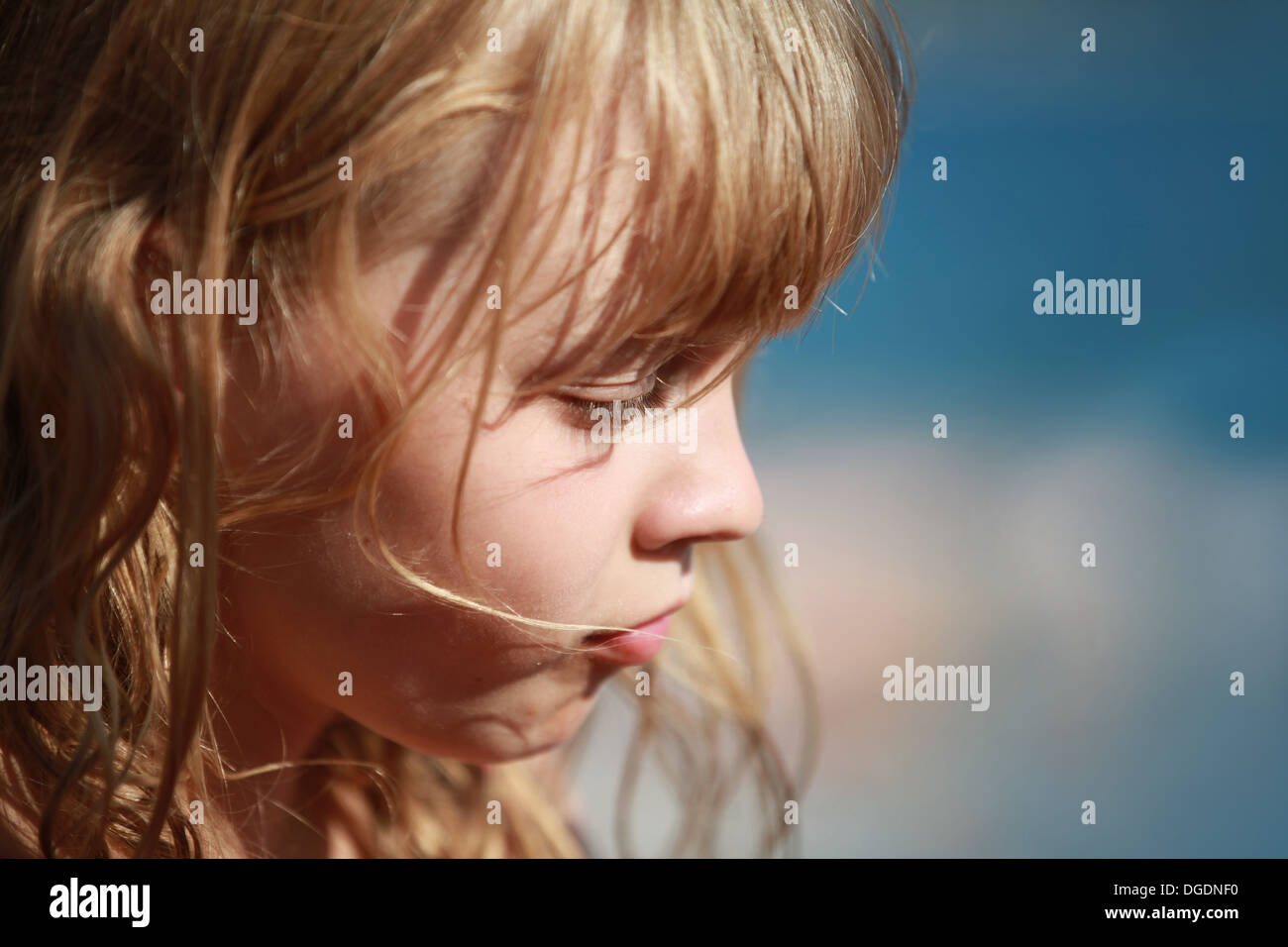 Closeup profile portrait of calm little blond girl Stock Photo