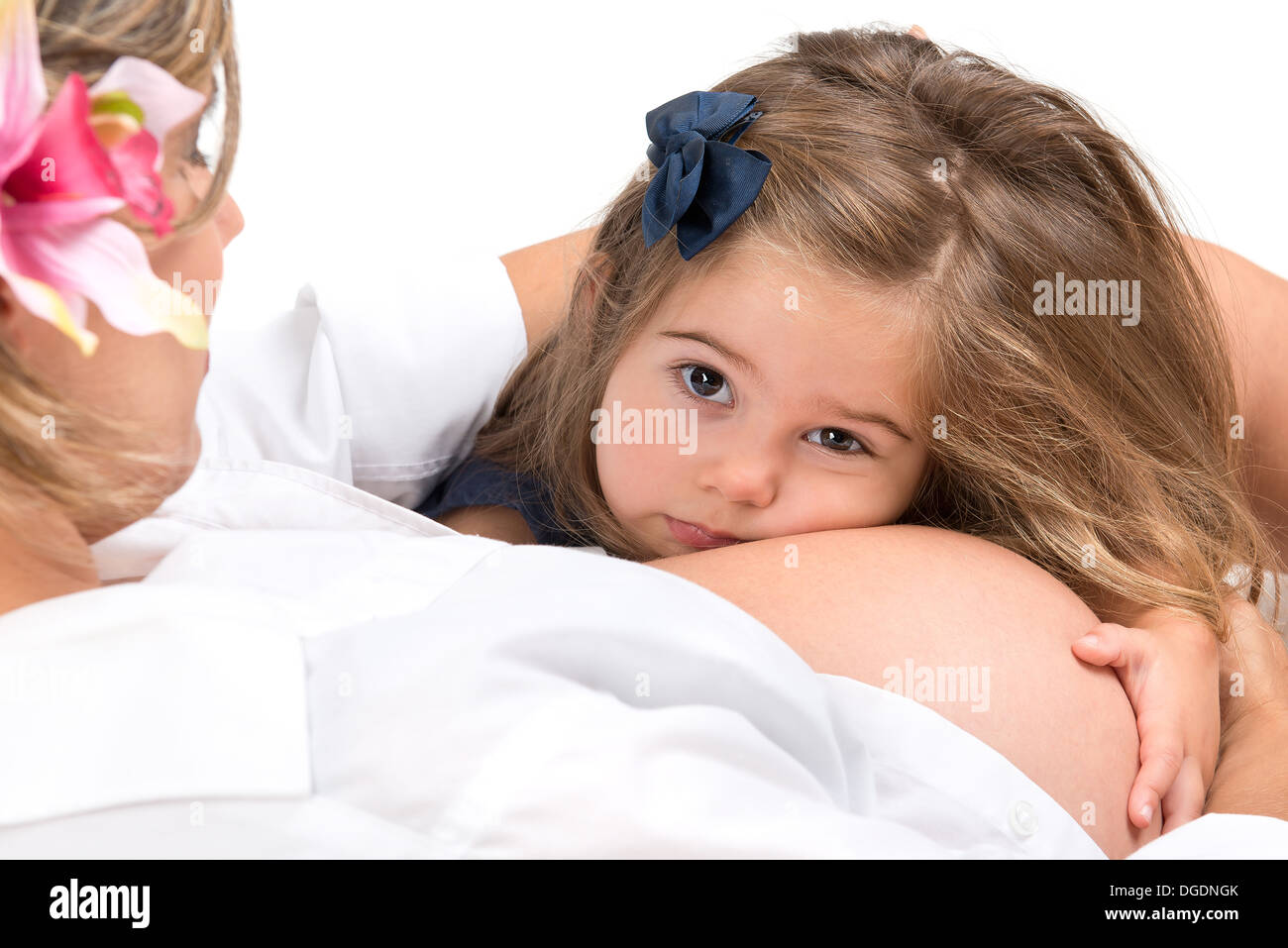 Beautiful young girl holding pregnant mother's belly Stock Photo