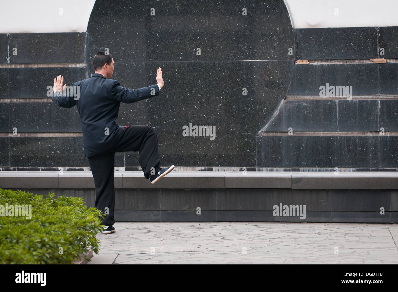 Office worker practicing Taijiquan (tai chi) in Pudong District, Shanghai, China Stock Photo