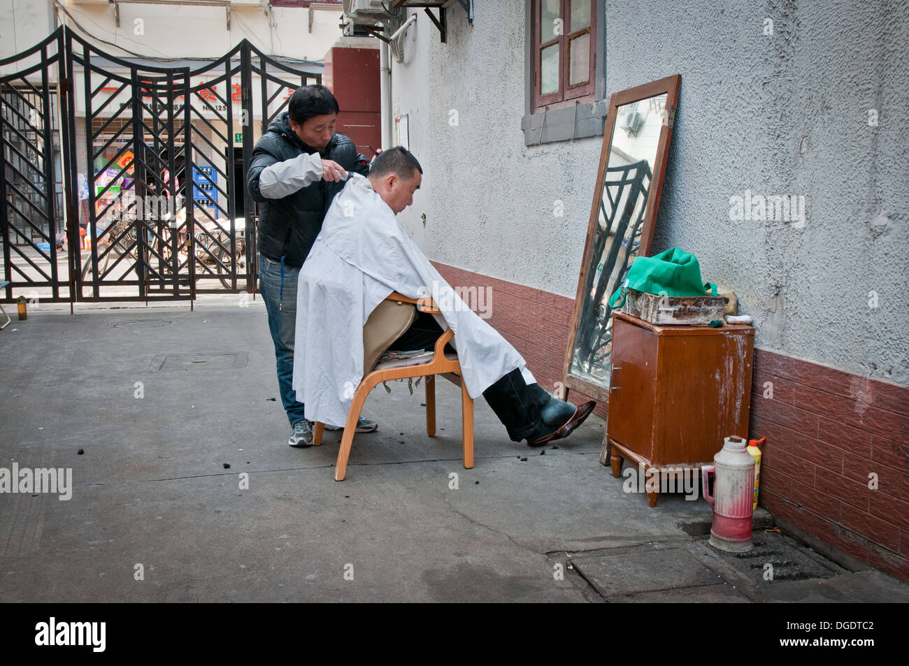 barber on street in Shanghai, China Stock Photo