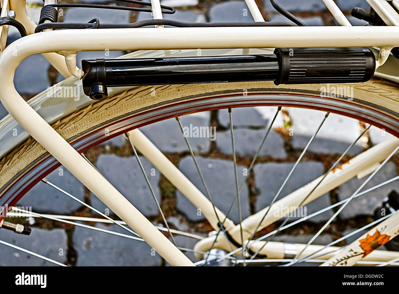 Detail of the rear wheel of the bicycle with air pump attached. Stock Photo