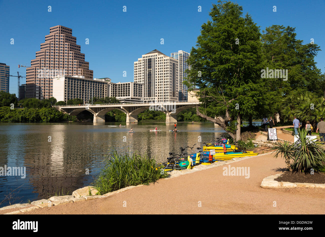 People enjoy paddling on Lady Bird Lake Austin skyline Texas USA Stock Photo