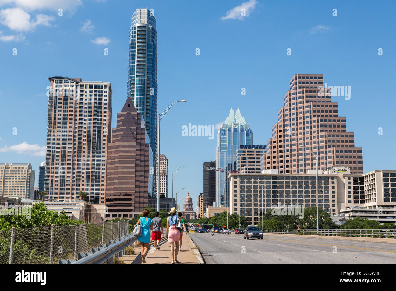 Traffic and tourists cross S Congress Avenue bridge with Austin skyline in background Texas USA Stock Photo