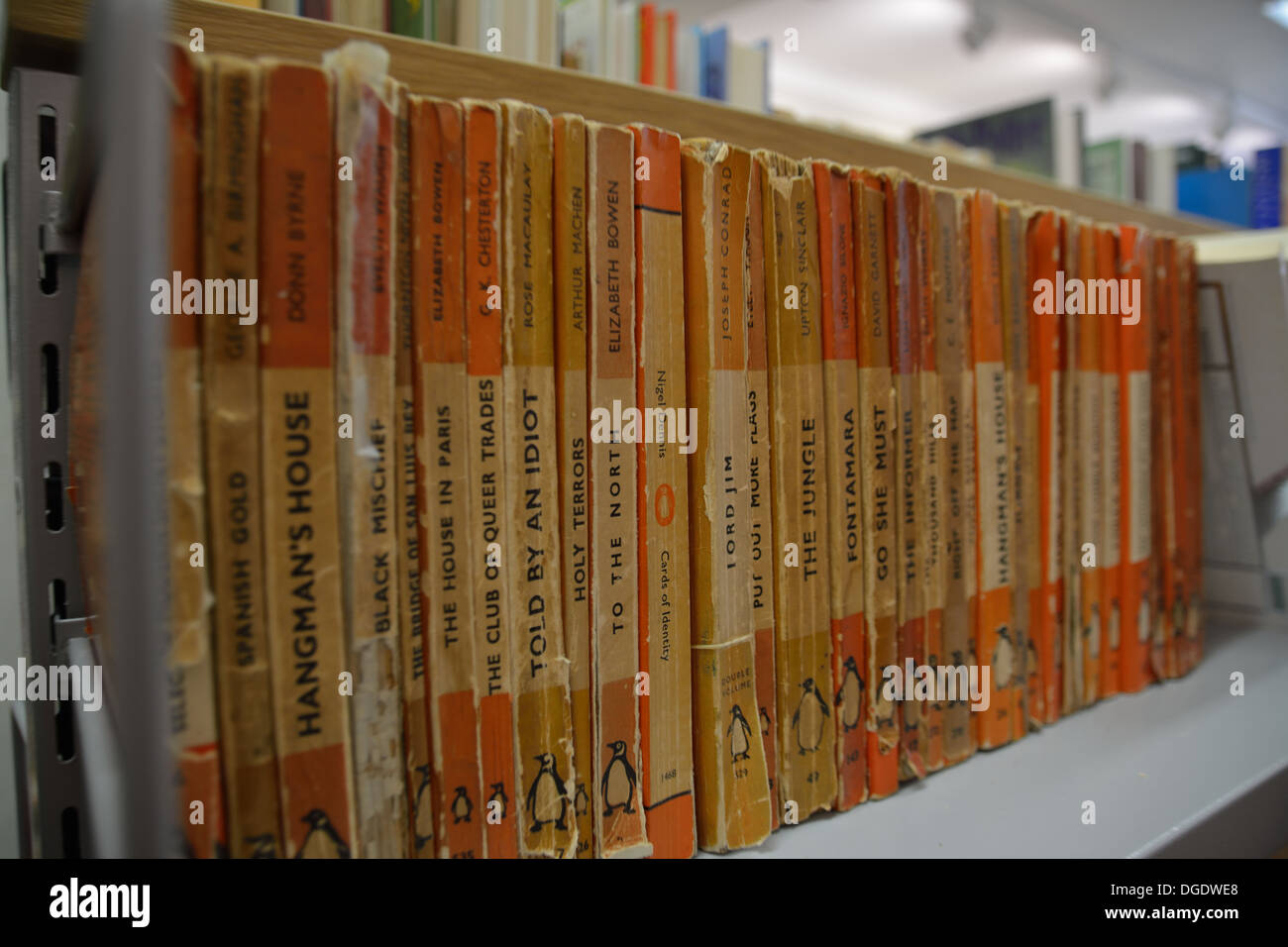 Row of old Penguin Classics for sale in a second hand book shop.  Chelmsford Town Centre, Essex. Stock Photo