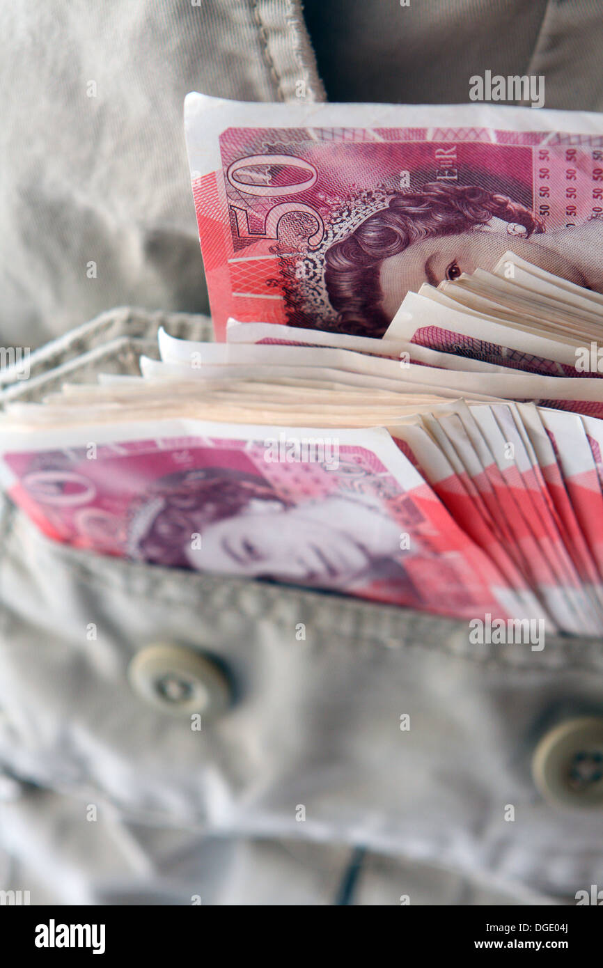 A bundle of sterling £50 notes sticking out of a trouser pocket Stock ...