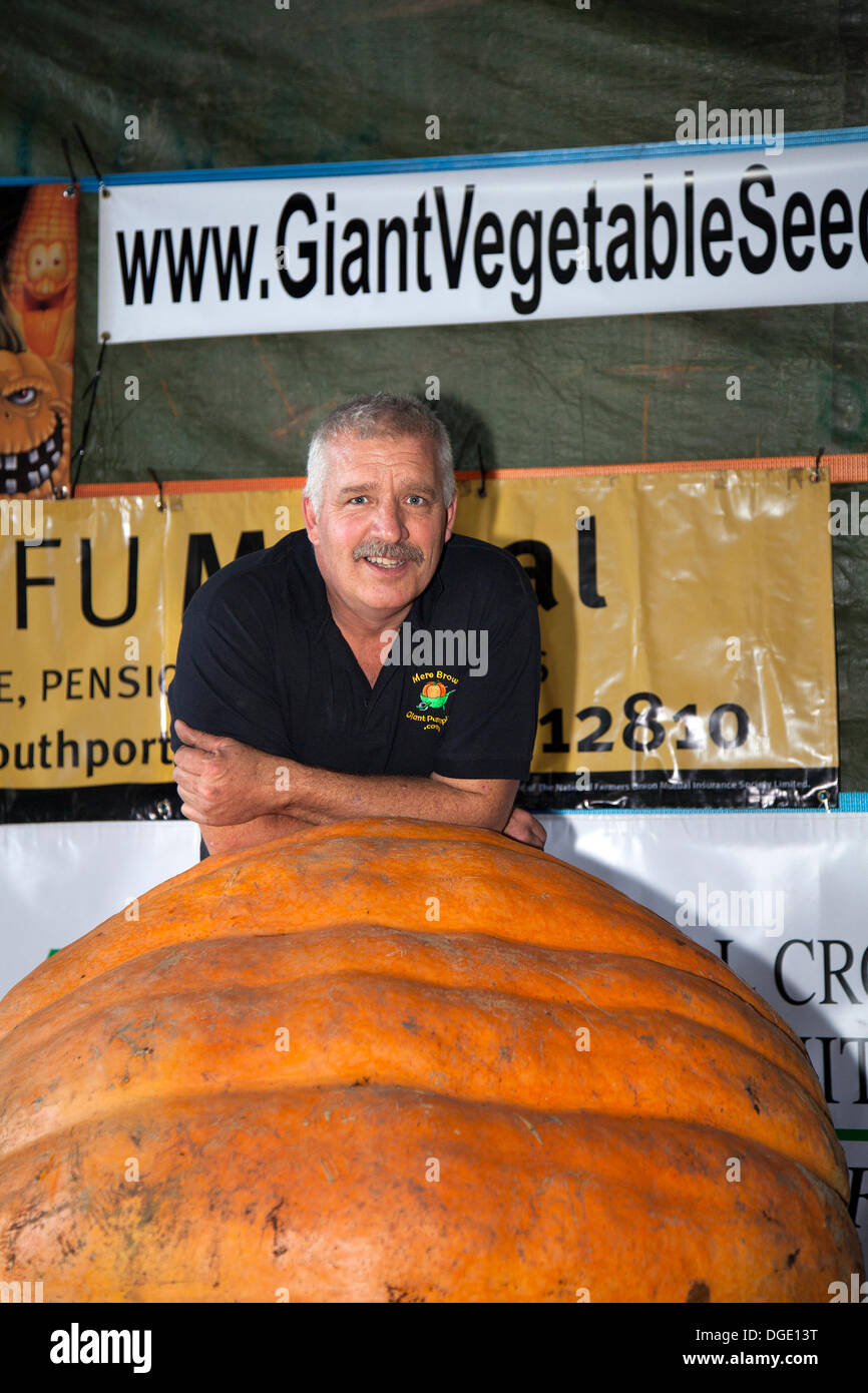 Giant Pumpkin Competition  Southport, UK.  19th October, 2013. MARK O'HANLON winner at the Mere Brow Giant Pumpkin Competition with his entry weighing 797 lbs. The event marks the 19th year of the event and as always raises as much money as possible for charity. HUGE pumpkins were on display at the annual celebration of the popular vegetable.  Mere Brow is a small village in Lancashire, England, situated between Tarleton and Banks. Stock Photo
