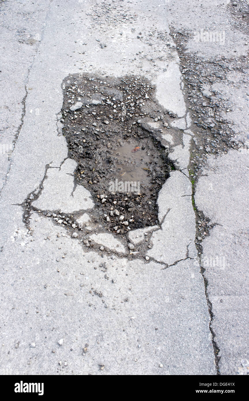 Pothole in UK pavement sidewalk Stock Photo Alamy