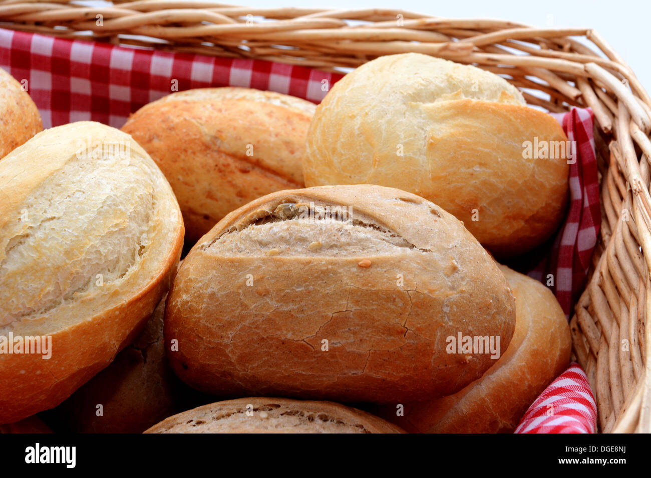 Closeup of tasty fresh crusty bread rolls in a wicker basket Stock Photo