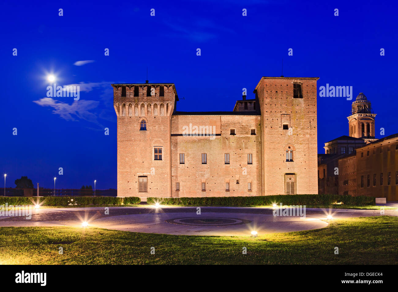 Italy Mantua ancient medieval knight castle tall stone towers walls at sunset full moon light and illumination Stock Photo