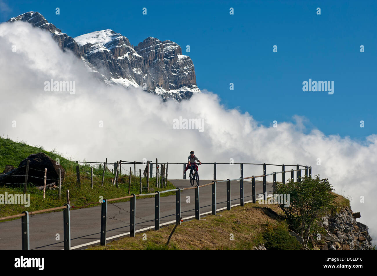 Biker on the mountain road to the pass Klausenpass, Urnerboden, Canton of Uri, Switzerland Stock Photo
