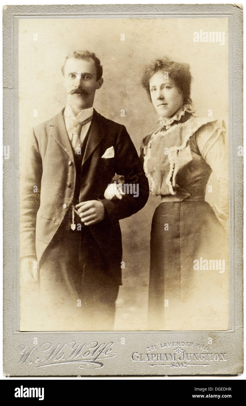 Victorian couple husband & wife circa 1895 studio portrait by photographer W.M. Wolfe of Clapham Junction London Stock Photo