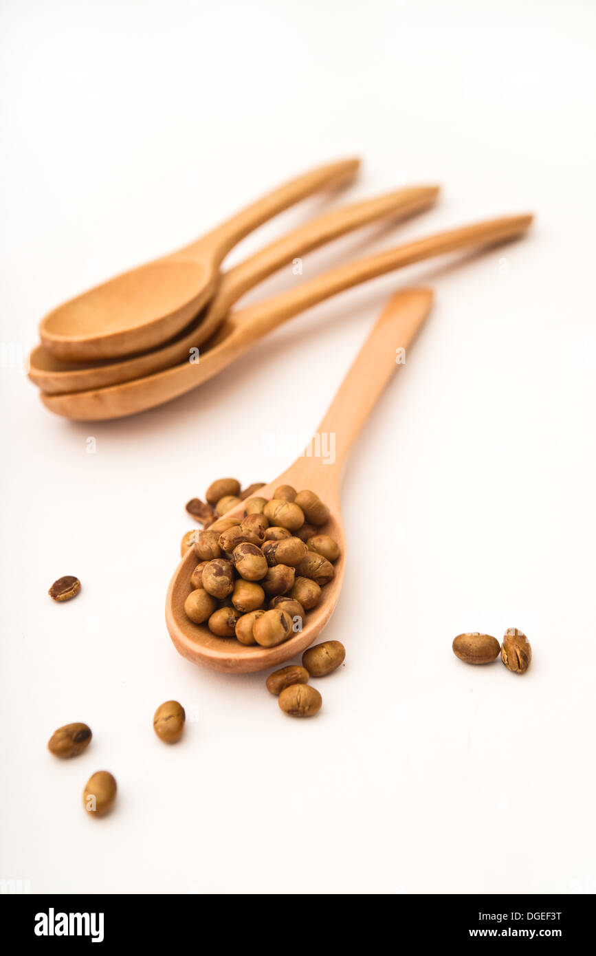 Soy beans on wood kitchen utensil on the table. Stock Photo