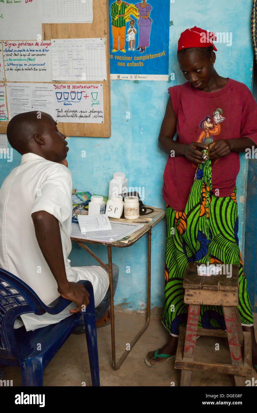 Female Patient Consulting with Health Practitioner at Nixo Village Health Clinic, near Sokone, Senegal Stock Photo