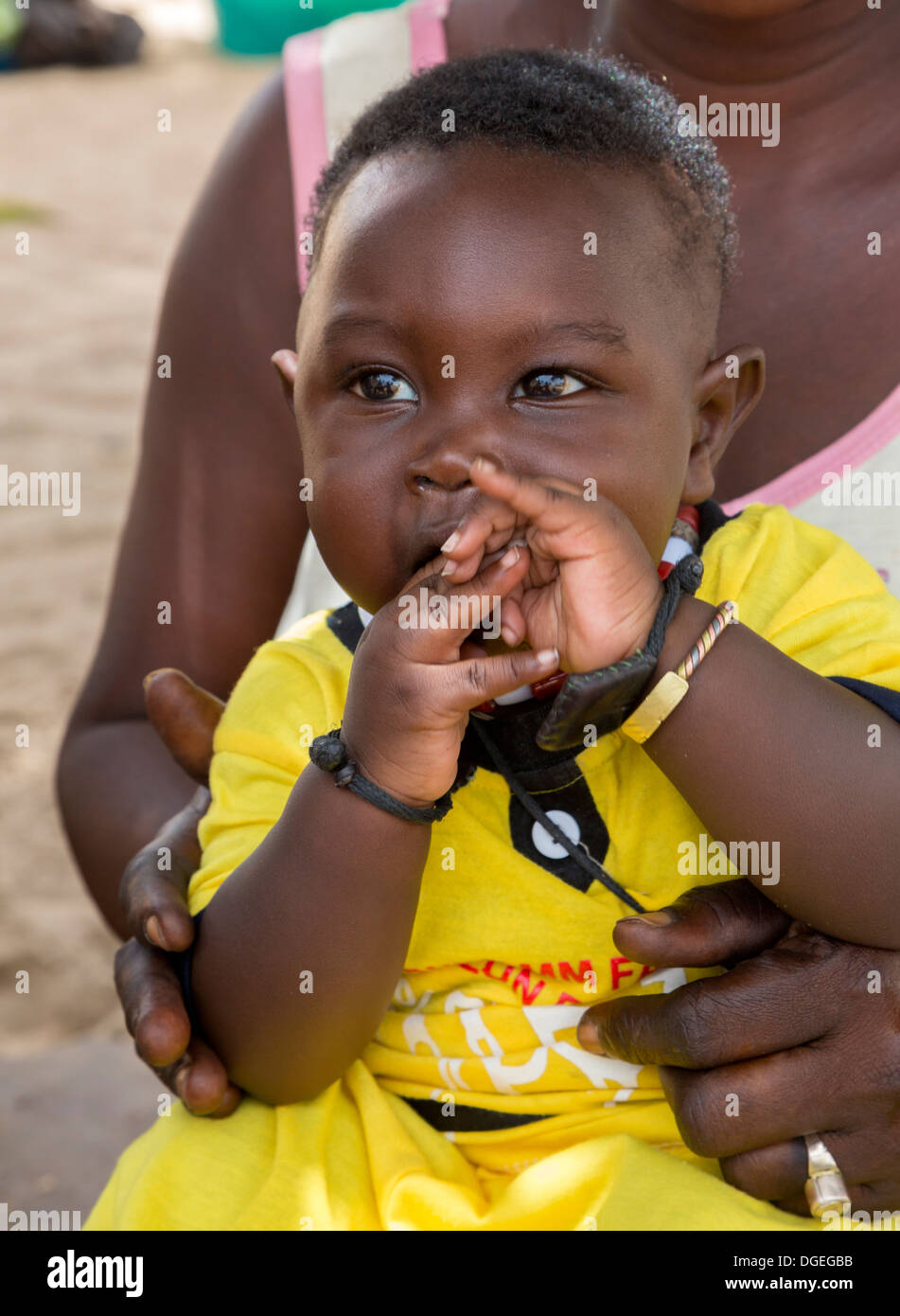 Little Boy in Mother's Lap, Nixo Village, near Sokone, Senegal. Serer Ethnic Group. Stock Photo