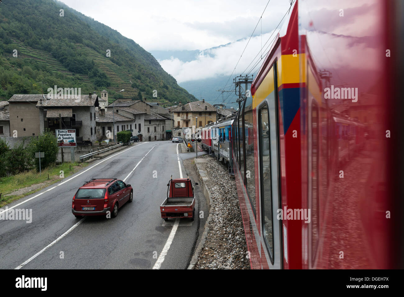 Bernina Express train approaching Tirano Station on the Italian border. Rhaetian Railway. Stock Photo