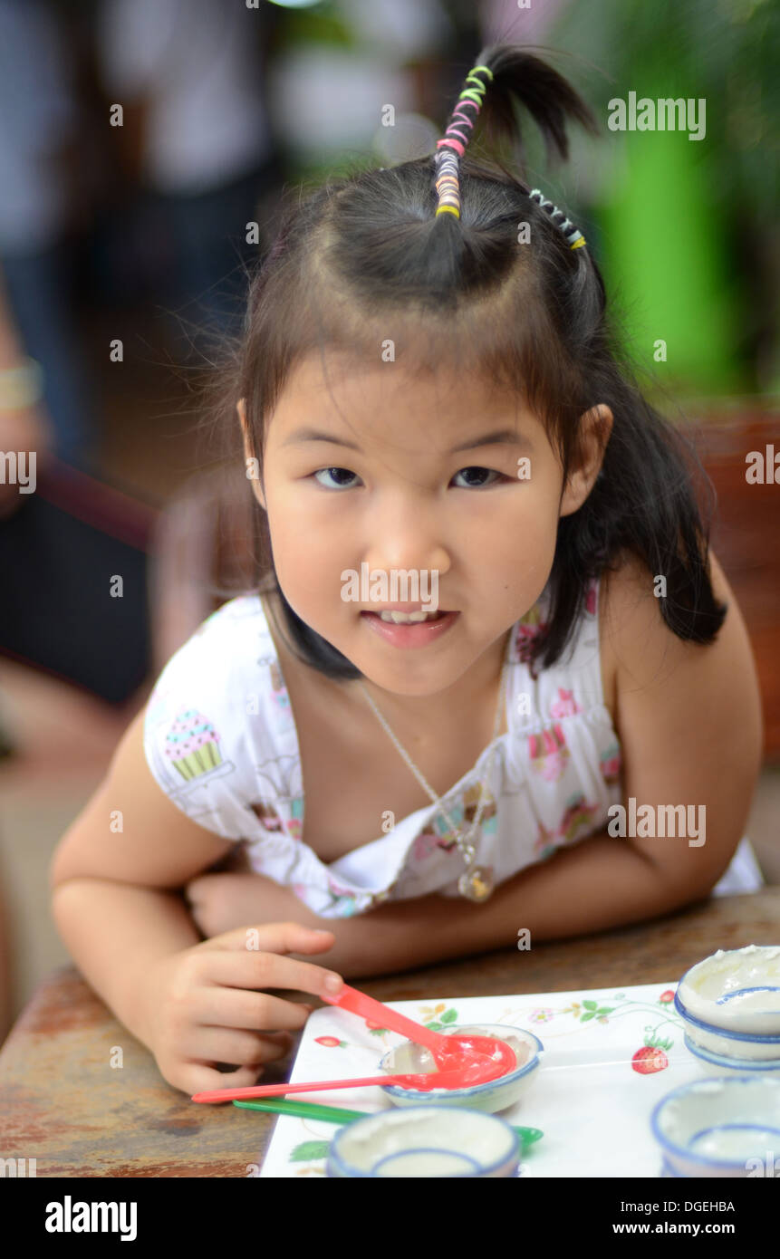 Closeup portrait of little Asian girl smile after eat sweet Stock Photo ...
