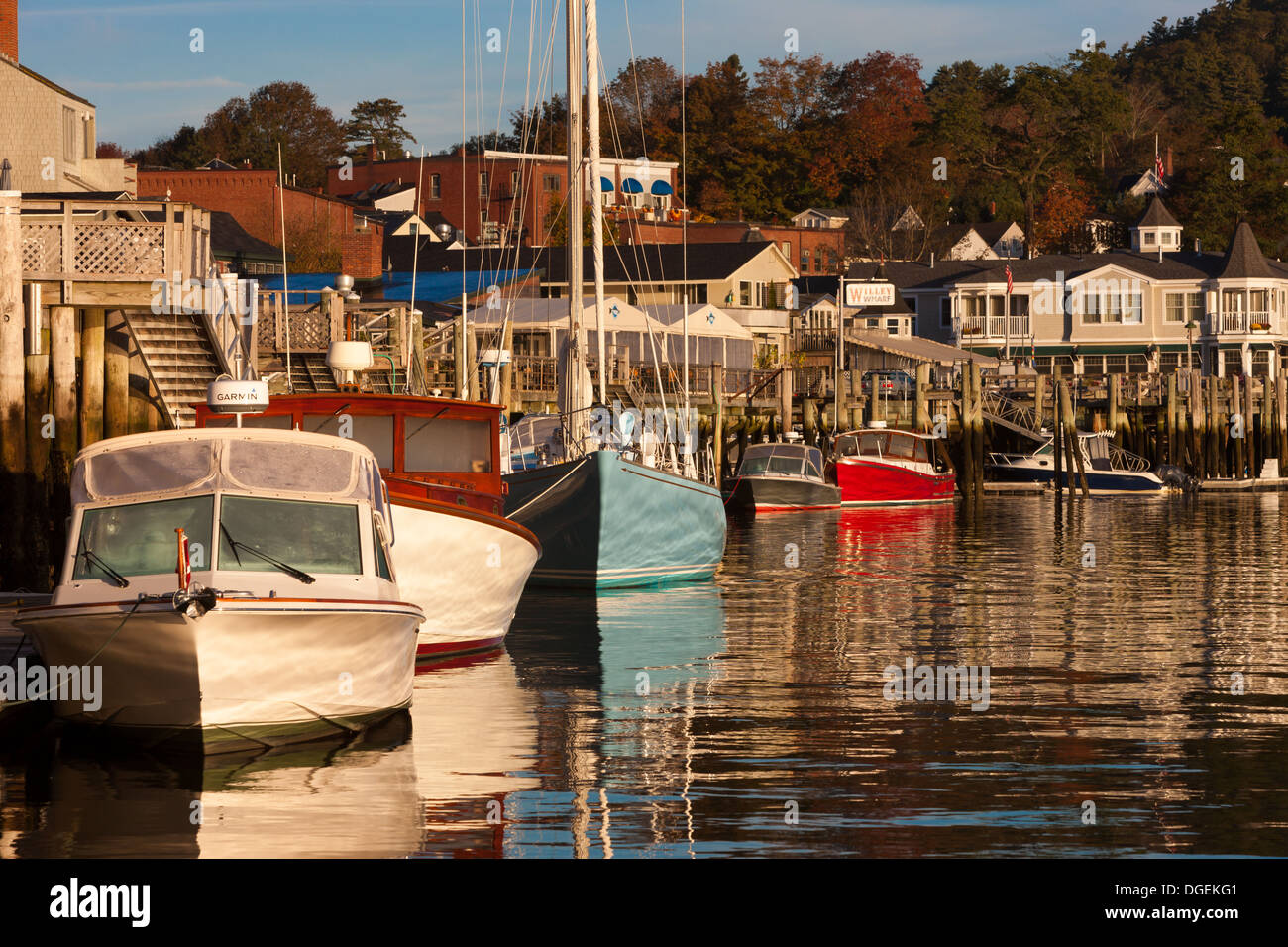 Boats and sailboats docked shortly after sunrise in Camden harbor, Camden, Maine. Stock Photo