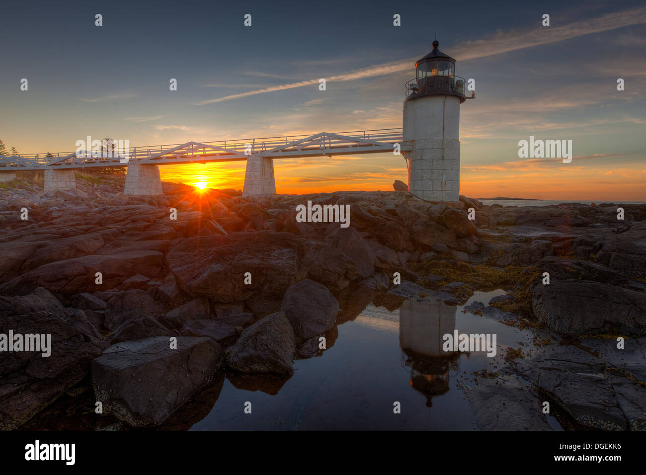 Marshall Point Lighthouse and its reflection in a tidal pool at sunrise in Port Clyde, Maine. Stock Photo