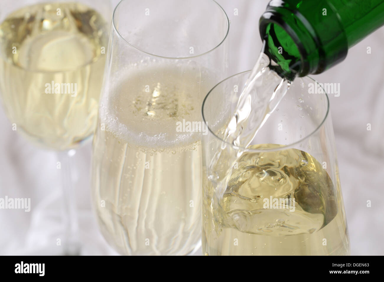 Sparkling Champagne pouring into a glass, selective focus Stock Photo