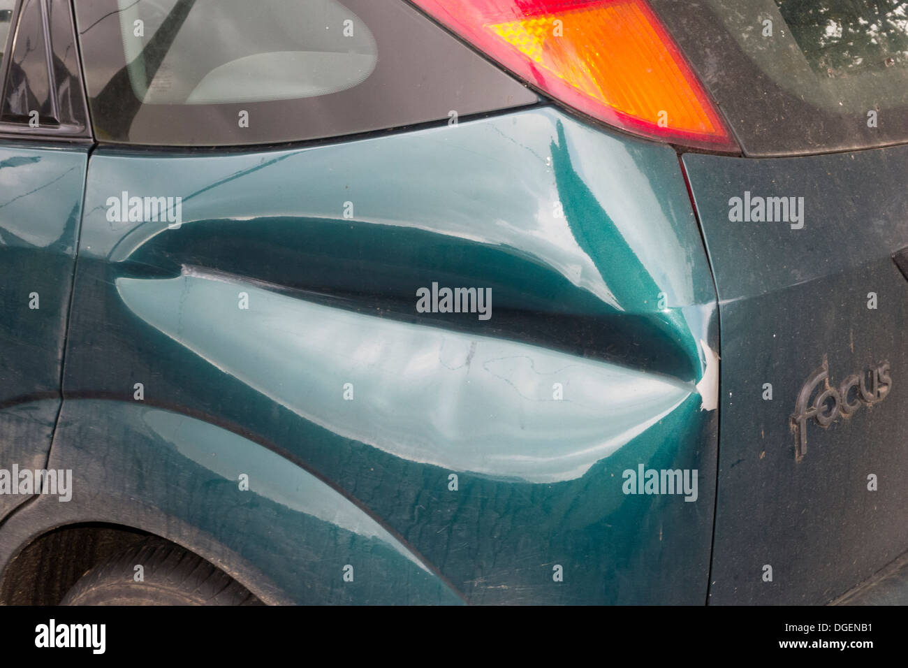 Panel Damage: a bad dent in a body panel on a Ford Focus car. Stock Photo
