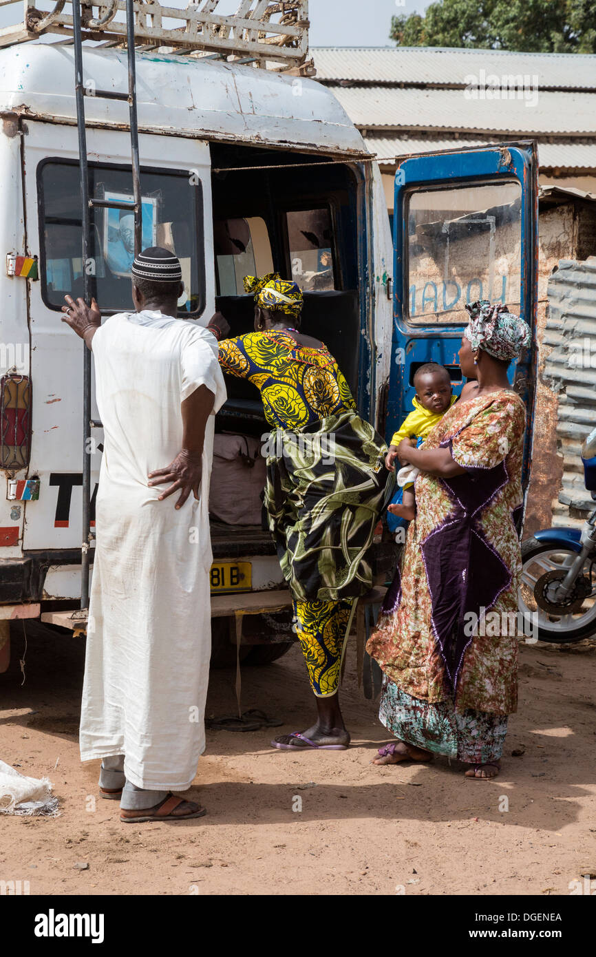 Women Passengers Boarding Local Transport, Weekly Market at Fass Njaga Choi, North Bank Region, The Gambia. Stock Photo
