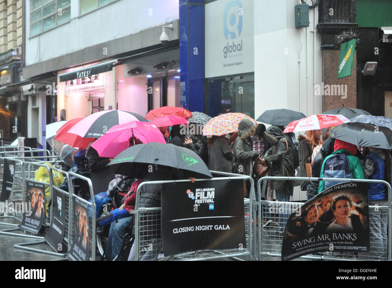 Leicester Square, London, UK. 20th October 2013. Film fans brave torrential rain in Leicester Square as they wait for tonight's closing gala of the British Film Festival, with the screening of Saving Mr Banks, starring Tom Hanks and Emma Thompson. Credit:  Matthew Chattle/Alamy Live News Stock Photo
