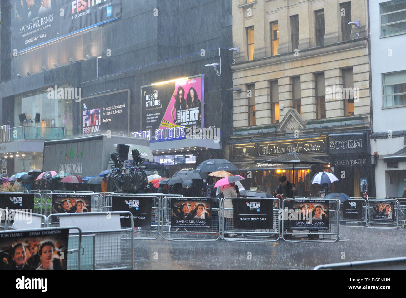 Leicester Square, London, UK. 20th October 2013. Film fans brave torrential rain in Leicester Square as they wait for tonight's closing gala of the British Film Festival, with the screening of Saving Mr Banks, starring Tom Hanks and Emma Thompson. Credit:  Matthew Chattle/Alamy Live News Stock Photo