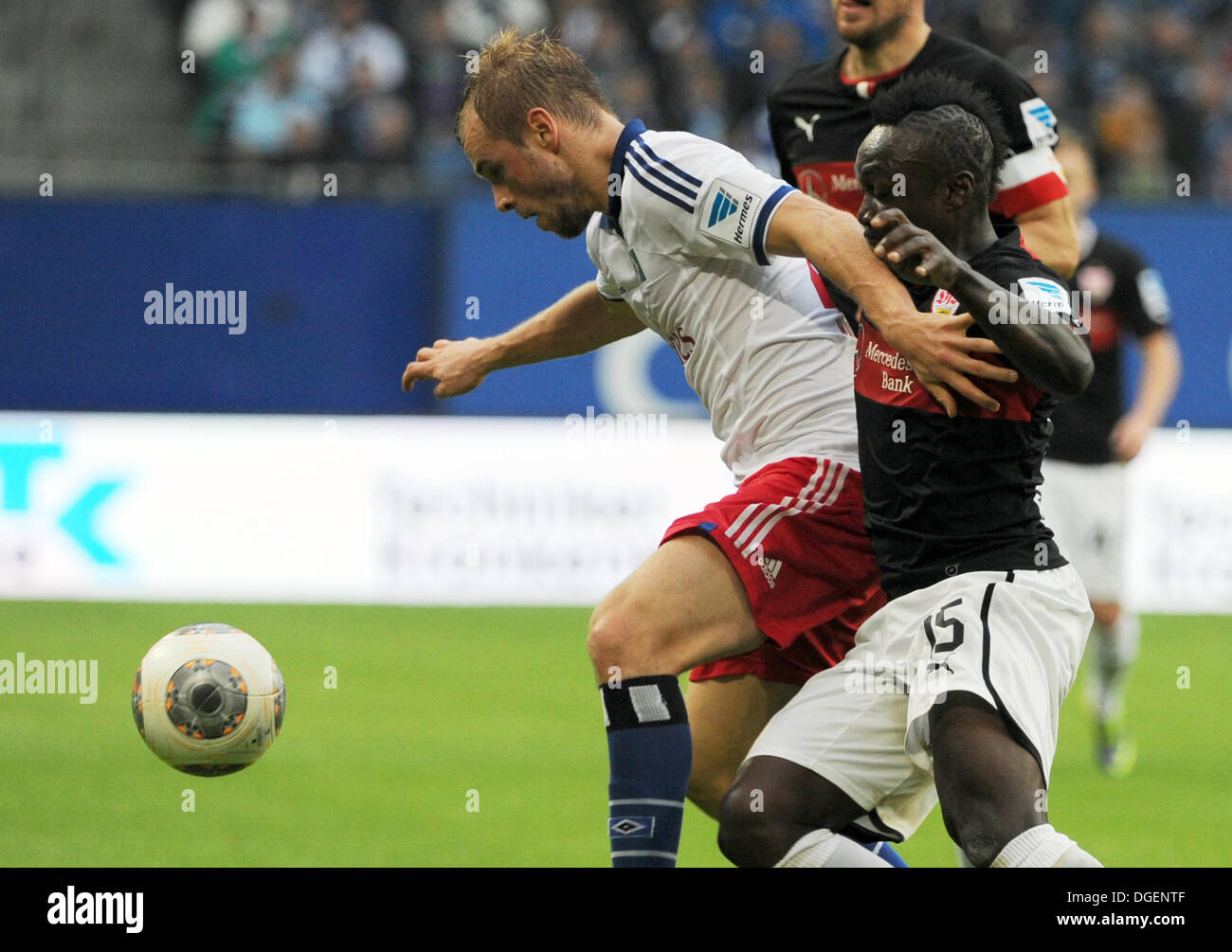 Hamburg, Germany. 20th Oct, 2013. Hamburg's Maximilian Beister (L) vies for the ball with Stuttgart's Arthur Boka (R) next to Stuttgart's Christian Gentner during the German Bundesliga soccer match between Hamburger SV and VfB Stuttgart at the Imtech Arena in Hamburg, Germany, 20 October 2013. Photo: ANGELIKA WARMUTH (ATTENTION: Due to the accreditation guidelines, the DFL only permits the publication and utilisation of up to 15 pictures per match on the internet and in online media during the match.)/dpa/Alamy Live News Stock Photo