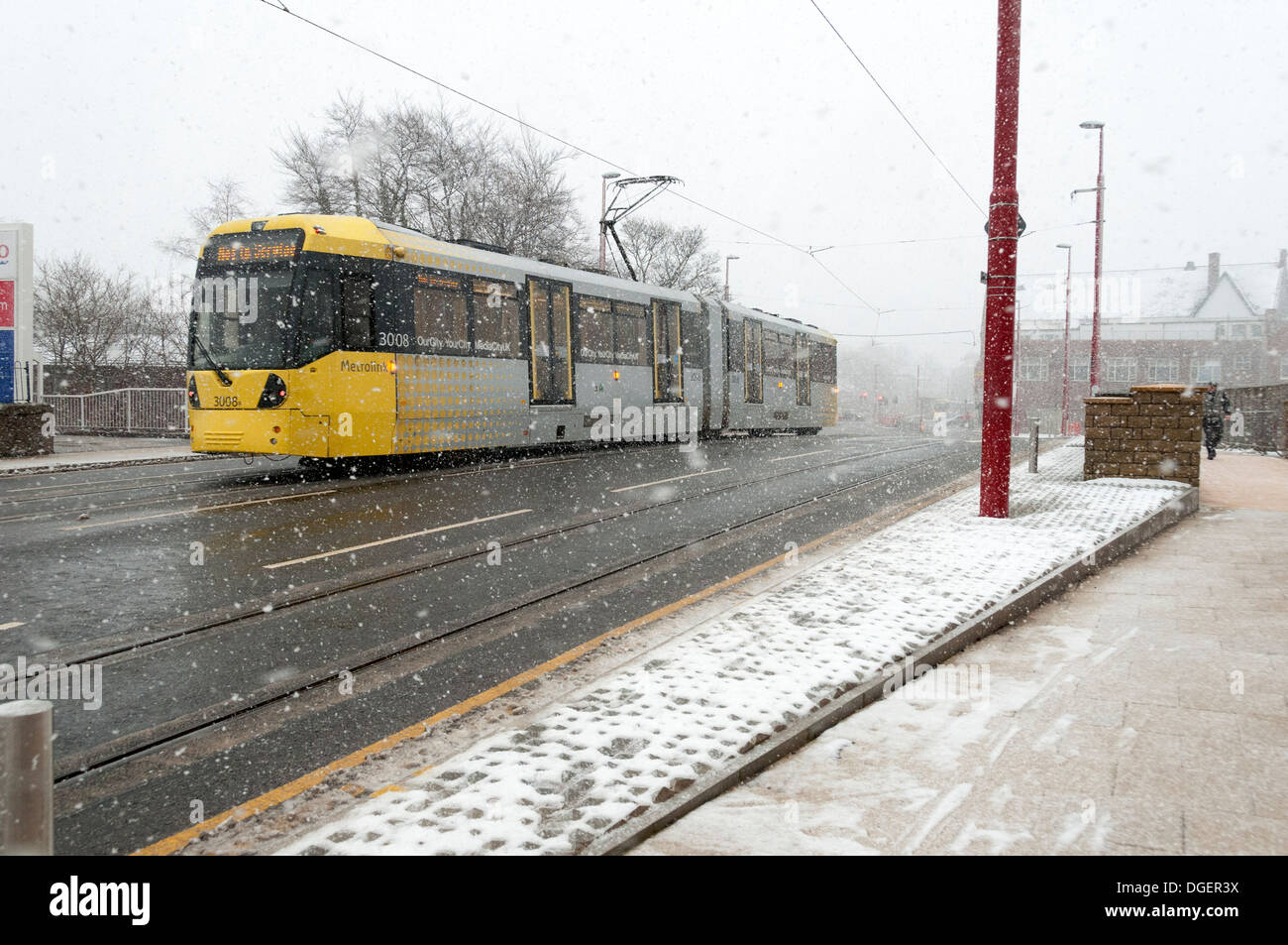 Manchester Metrolink tram in snow, during testing on the East Manchester Line, Droylsden, Tameside, Manchester, England, UK Stock Photo