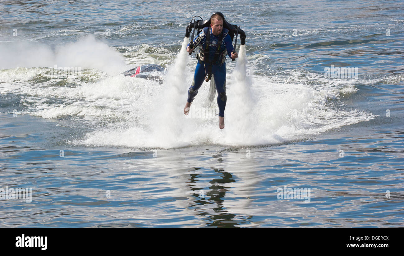 Man piloting a water powered jet pack at high speed Royal Victoria Dock London England Europe Stock Photo