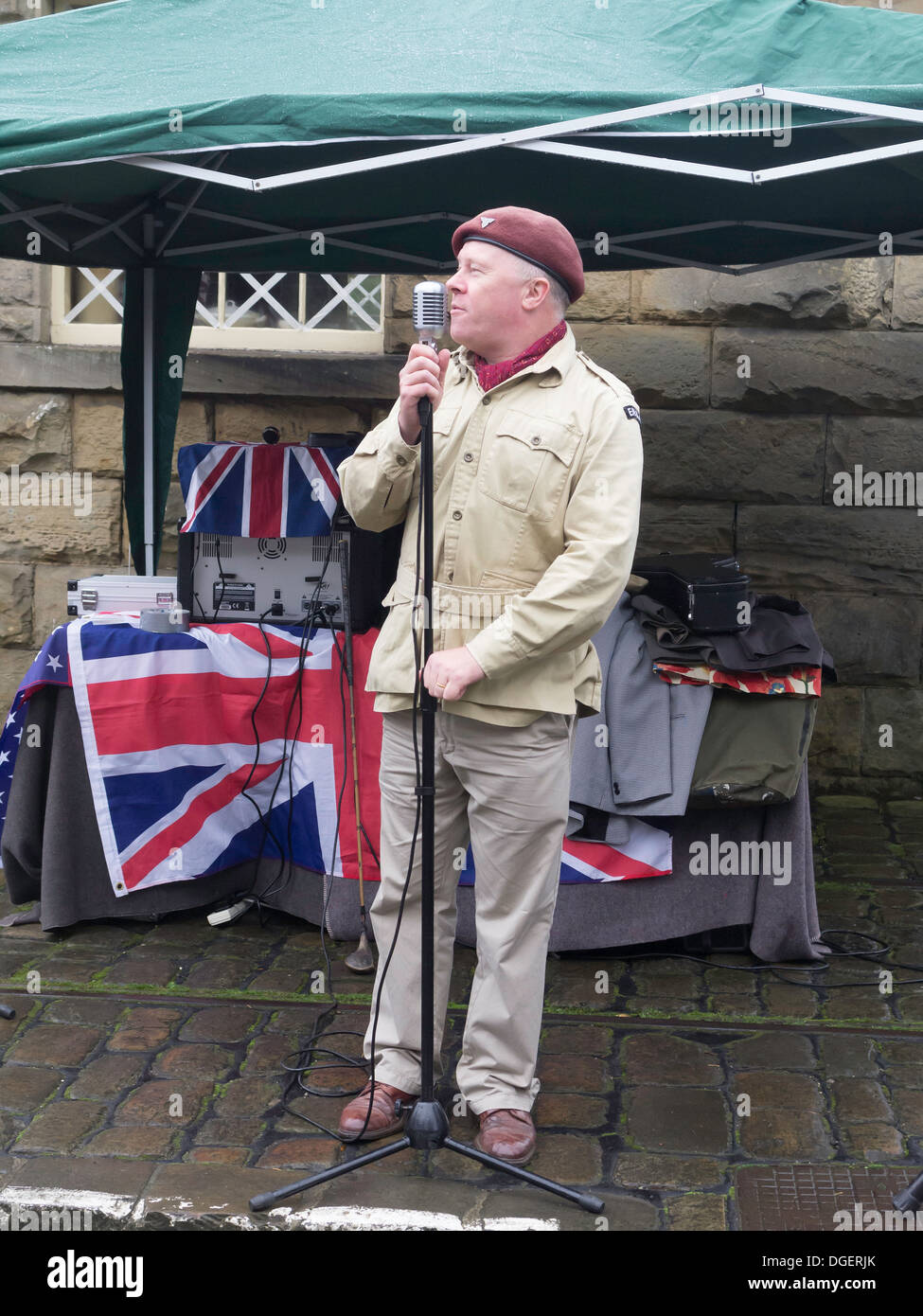 A man dressed as a paratrooper compère of music on Goathland Station NYMR during the Railway in Wartime week-end October 2013 Stock Photo